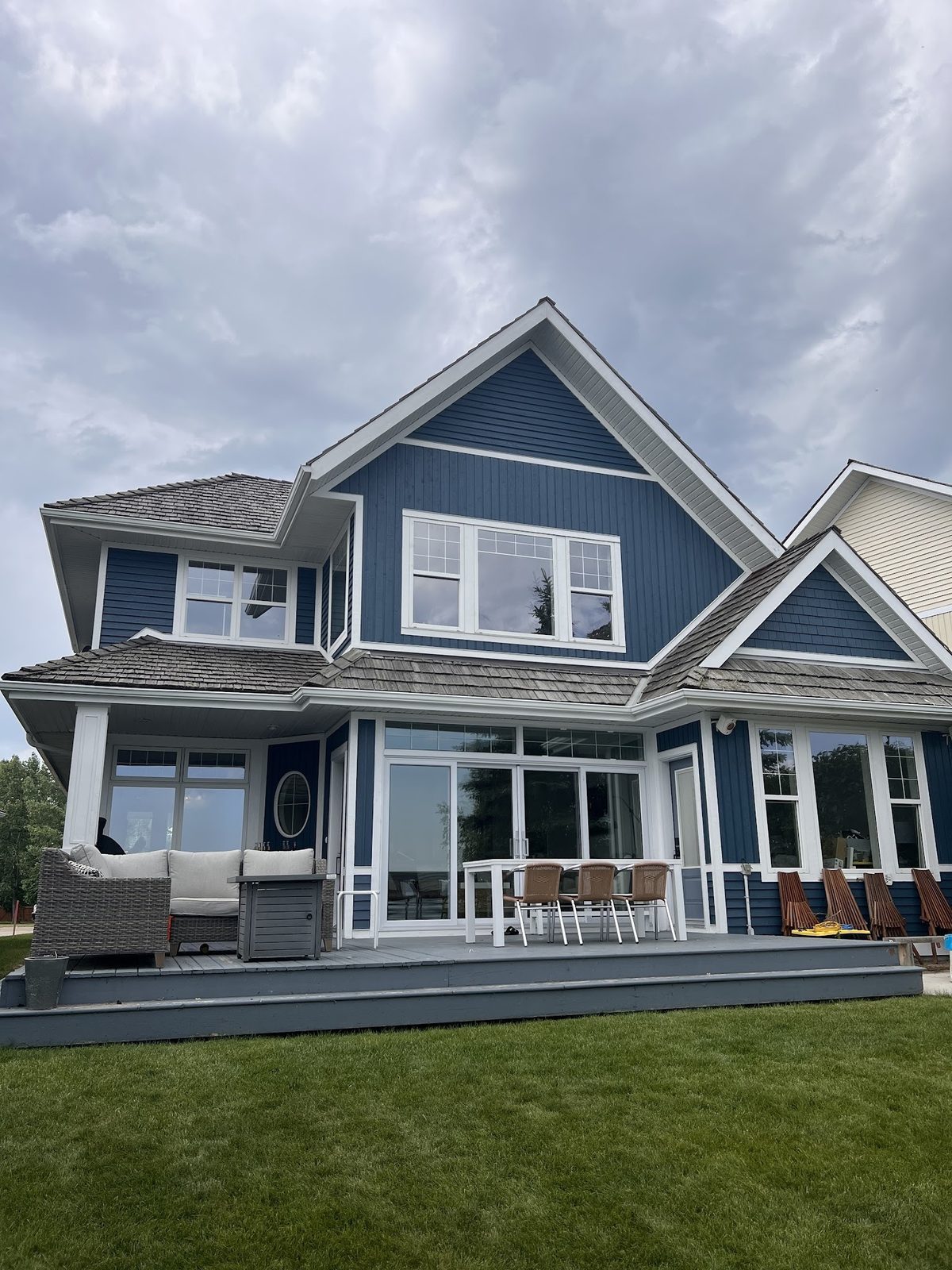 Navy blue exterior repaint on a two-storey Red Deer home